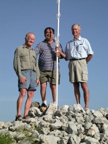 A group of people standing on a rock Description automatically generated